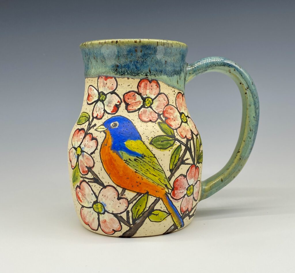 Handmade pottery mug with bunting bird illustration on speckled stoneware, glazed interior