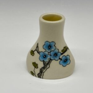 Hand-painted mini ceramic vase with blue blossom floral design on cream background