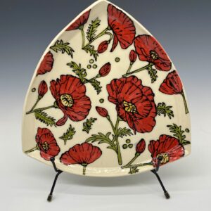 Triangle porcelain plate with embossed and hand-painted red poppies – front view.