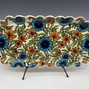 Large handmade porcelain platter with embossed floral design and scalloped edges – front view.