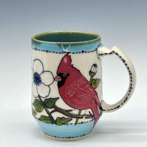 Hand-painted ceramic mug featuring a red cardinal among white flowers with turquoise accents, view 0