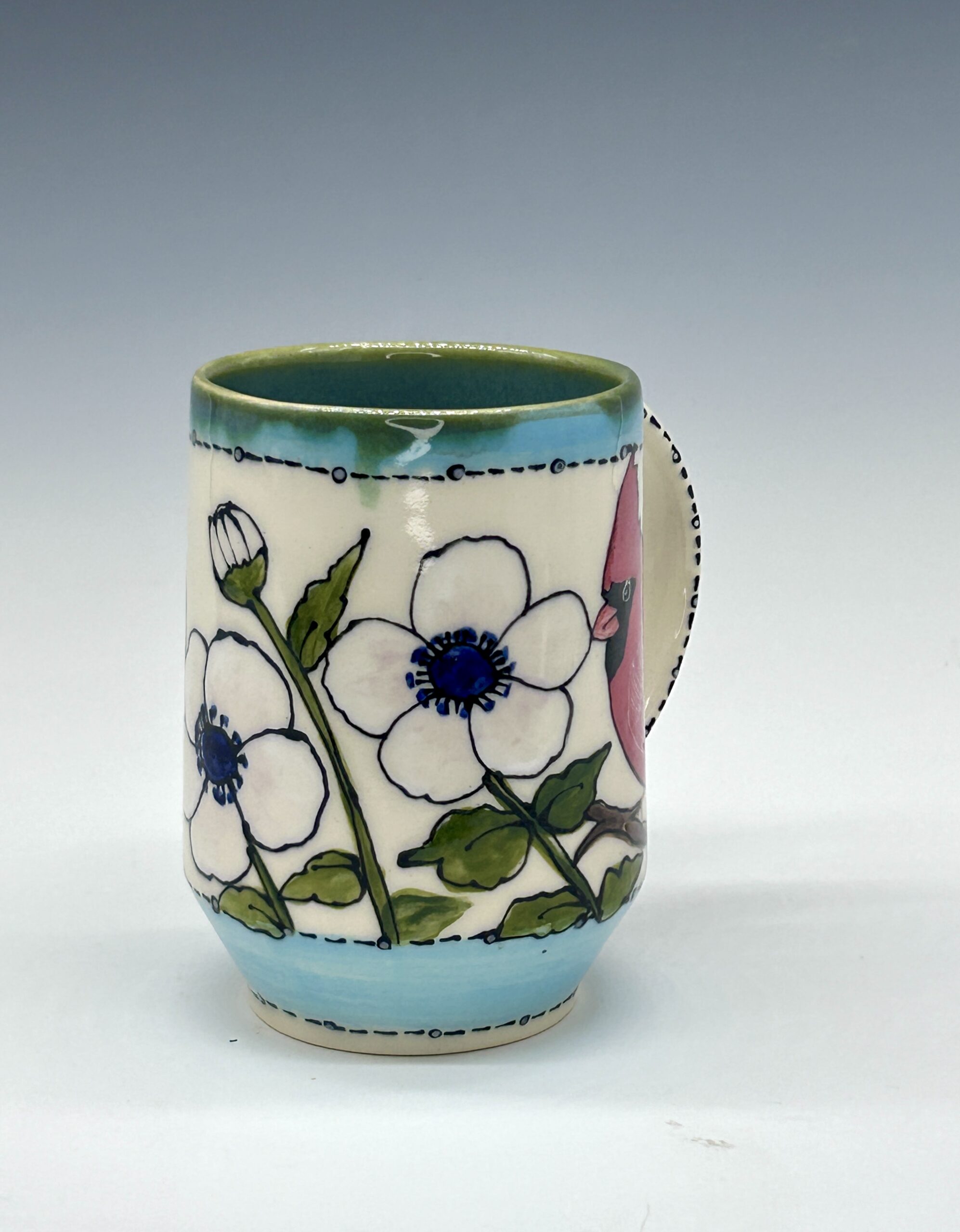 Hand-painted ceramic mug featuring a red cardinal among white flowers with turquoise accents, view 1