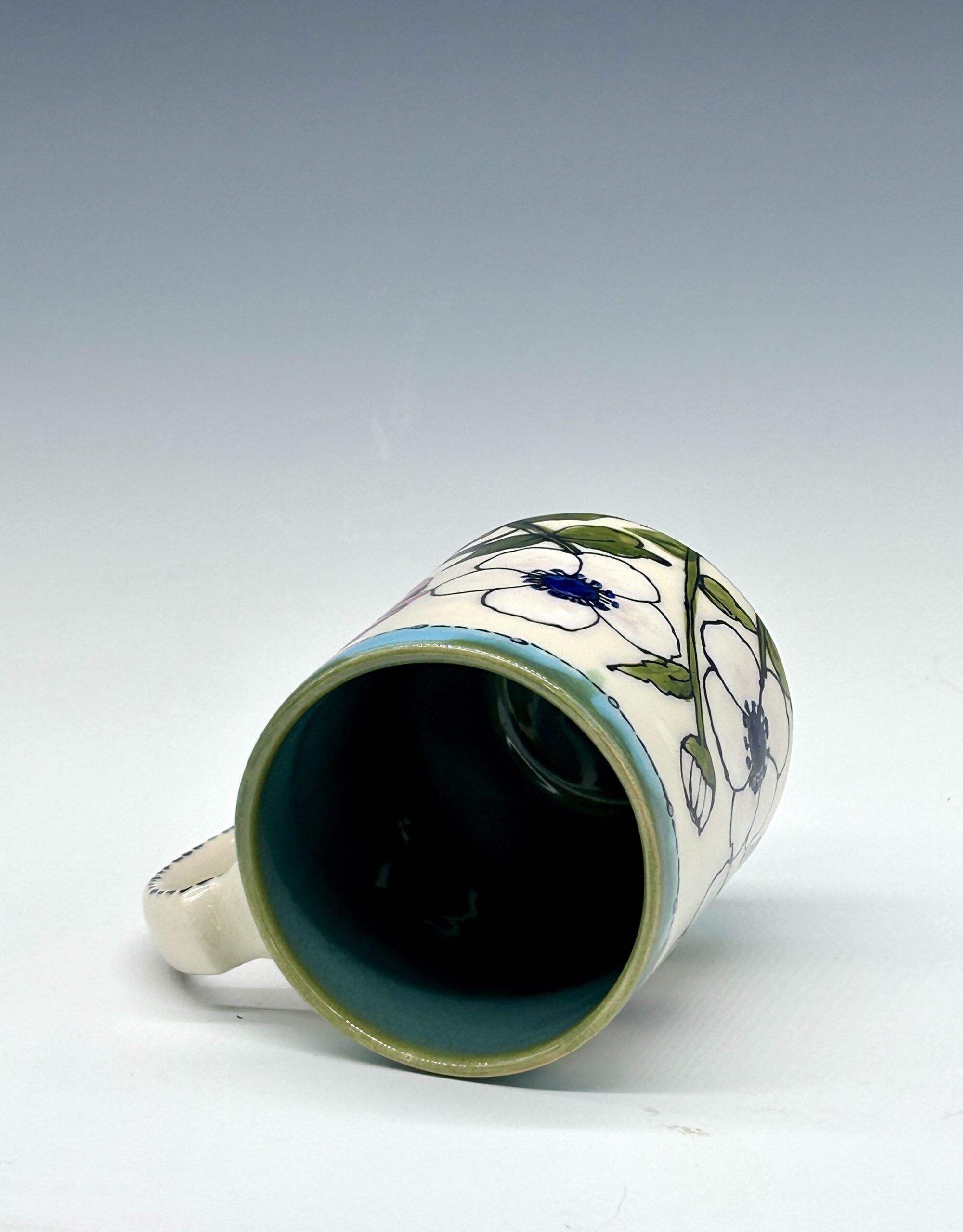 Hand-painted ceramic mug featuring a red cardinal among white flowers with turquoise accents, view 3
