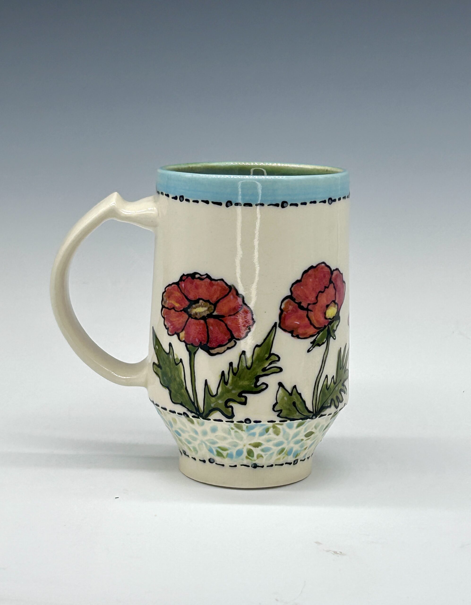 Hand-painted ceramic mug featuring a green and orange hummingbird among pink flowers, view 2